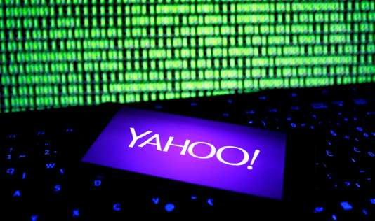 FILE PHOTO: A photo illustration shows a Yahoo logo on smartphone in front of a displayed cyber code and keyboard